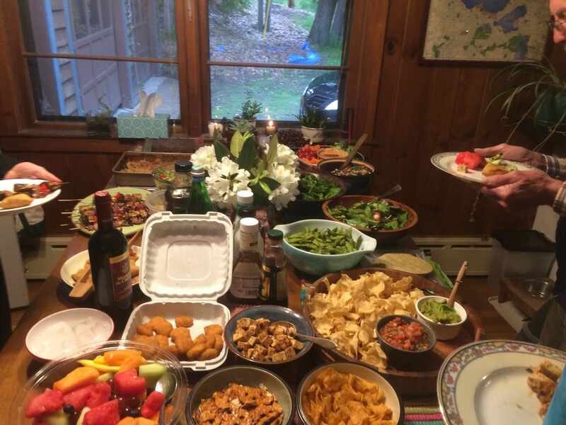 A long table covered with many dishes of home-cooked food